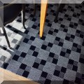 DR04. Black and white checkered rug. Measures approx. 8' x 11' 